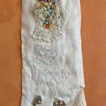 GRANDMA BROUGHT THE FLOWERS, 2022,, 22.5"x7", Janet's linen shirt sleeve, antique petticoat, doilies, embroidery floss